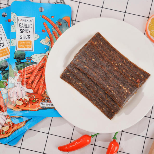 	Close-up of Traditional Hot and Spicy Stick texture - chewy strip grain snack, Hot Spicy flavor, vacuum-packed